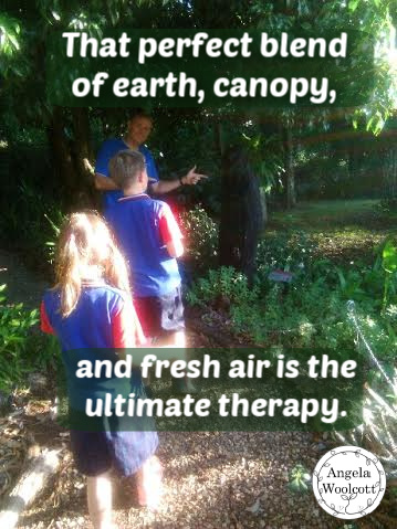 Family on a rainforest walk with local artist sculptures and beautiful plants along the way, with a positive quote overlay.