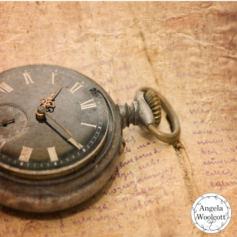 Photo of an old fashioned stop watch and brown paper with writing in the background.