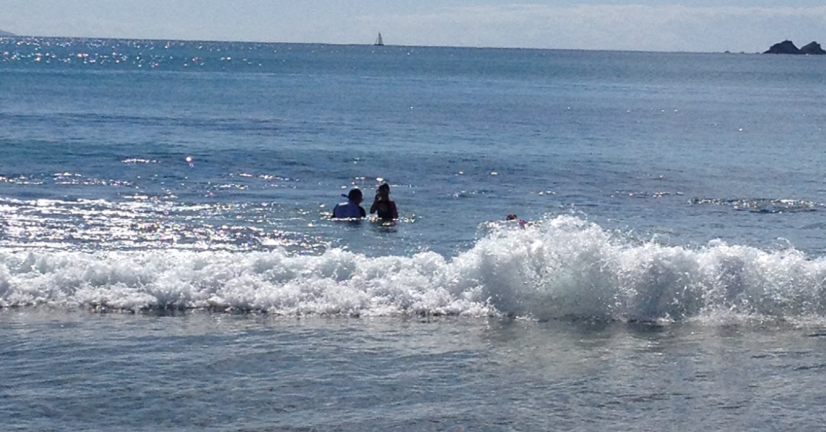 Two people snorkelling in ocean, Byron Bay.