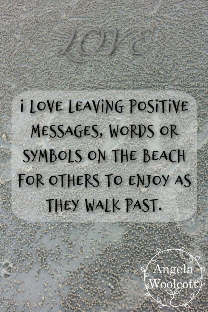 A picture of sand with carvings with a positive quote.